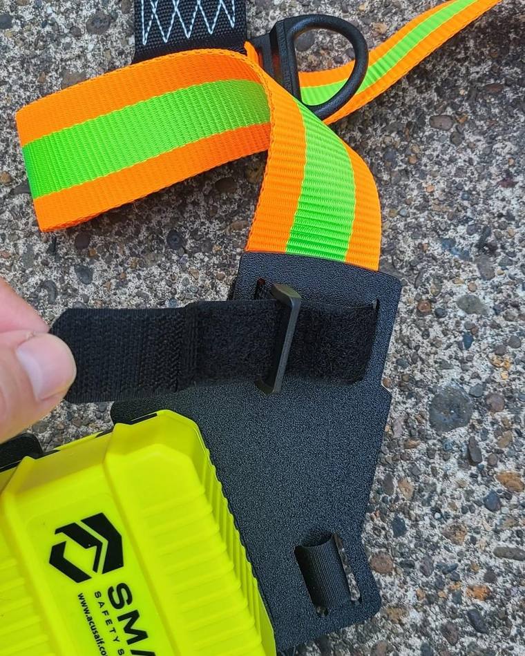 Hand feeding the shoulder Velcro strap through the mounting plate slot